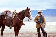 thumbnail link to photograph of Steve outdoors with horse and rifle as Tom Horn