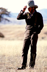 thumbnail link to photograph of Steve as Tom Horn on location, tipping his hat