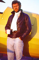 McQueen in flying jacket by plane