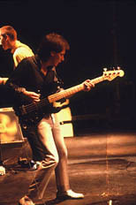 thumbnail link to photograph Bruce Foxton on stage playing bass, Paul Weller behind